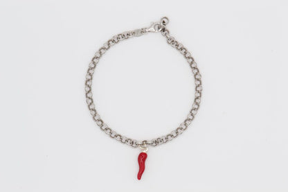 Silver bracelet with red horn